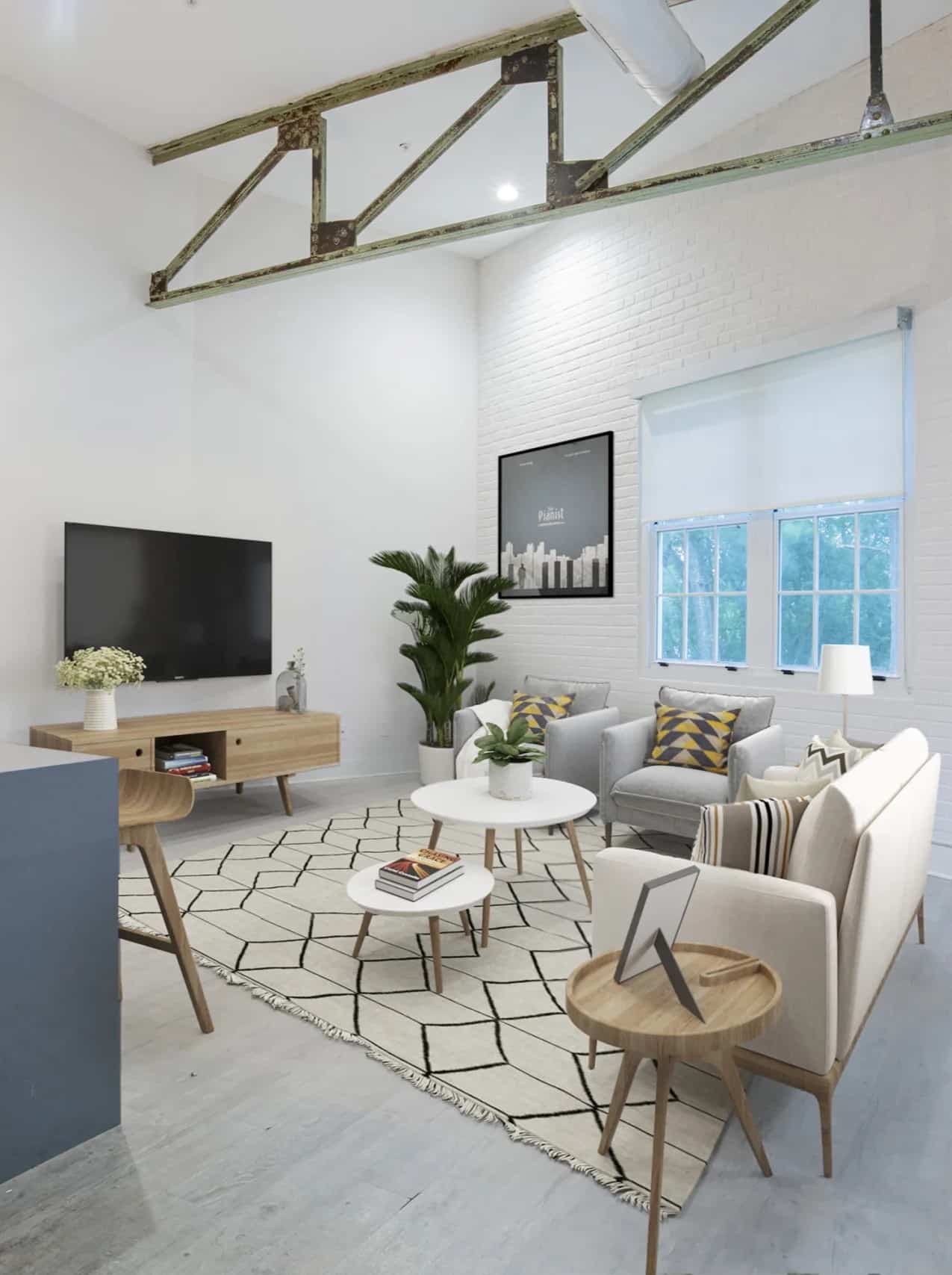 Modern living room with neutral furniture, geometric rug, wall-mounted TV, large window with white shade, indoor plant, and exposed beam on a high ceiling.